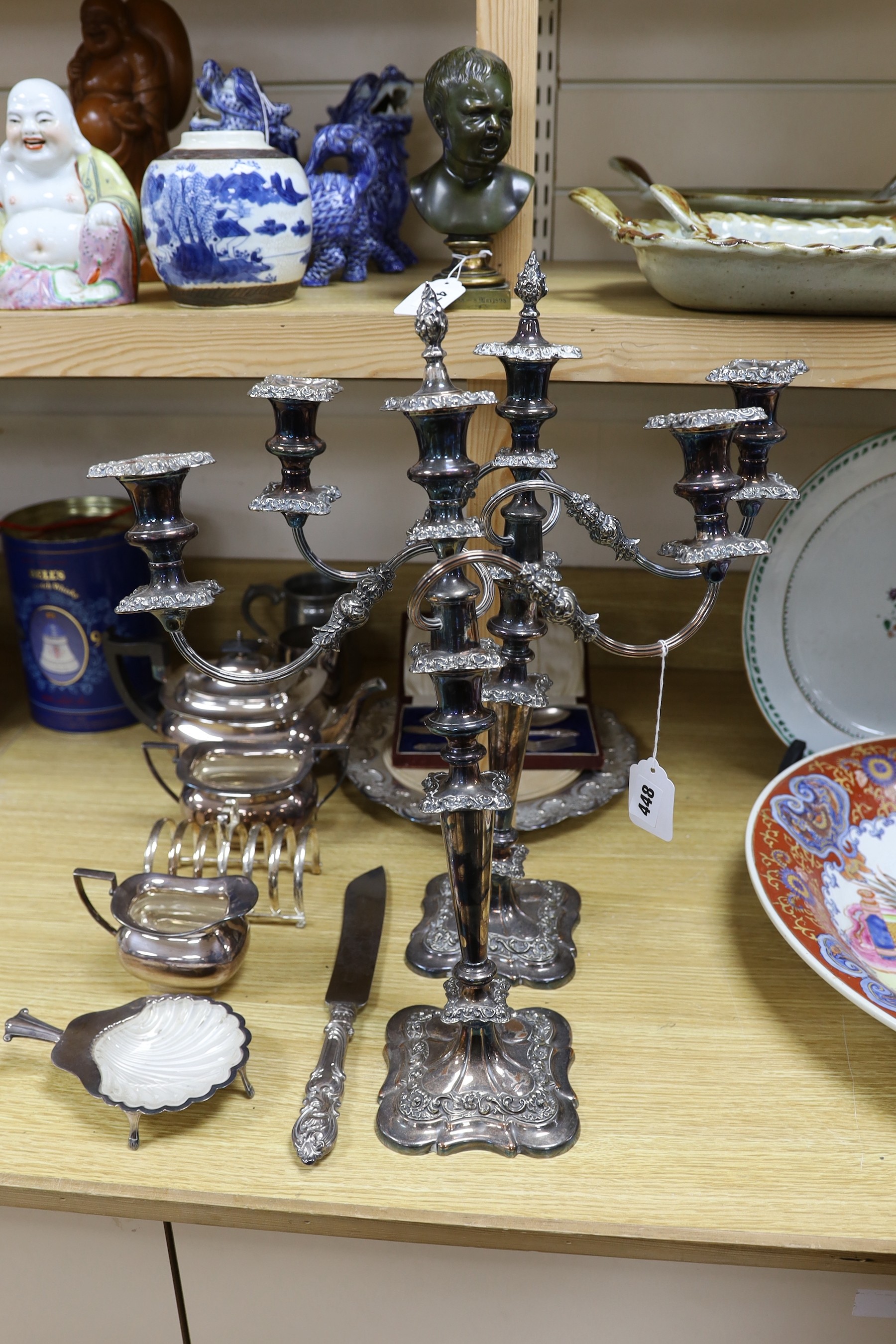 Assorted plated wares including a pair of three light candelabra, 52cms high